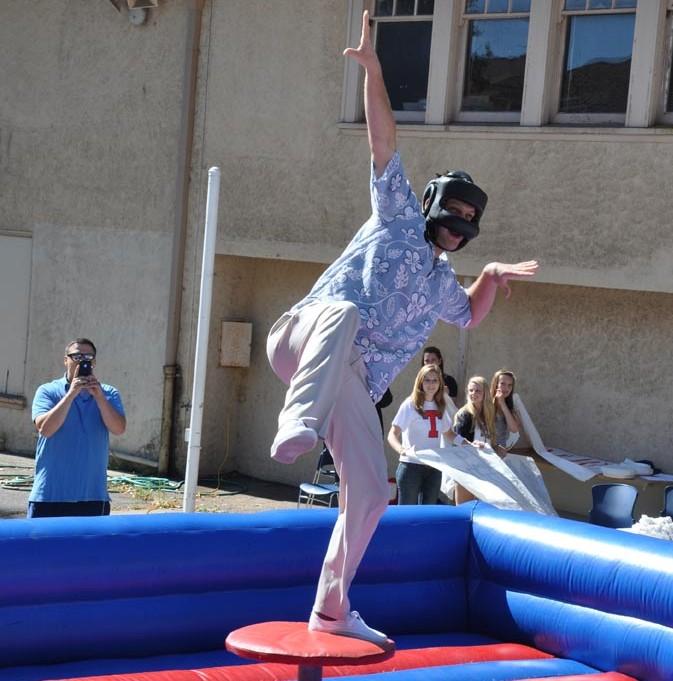 FIGHT IT OUT: Senior Charlie Eddy jousts with new assistant principal Chad Stuart at this year’s Welcome Back Rally.       Photo by: Kristina Willis