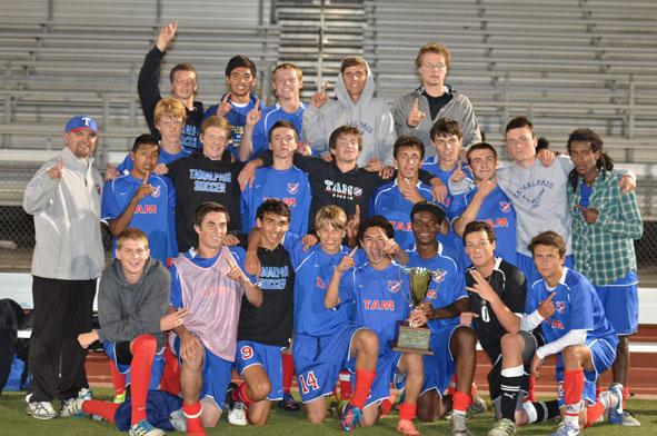 The boys varsity team celebrates their first place finish in the Bay City Invitational tournament on August 24. Photo courtesy of Ken Rosenberg.