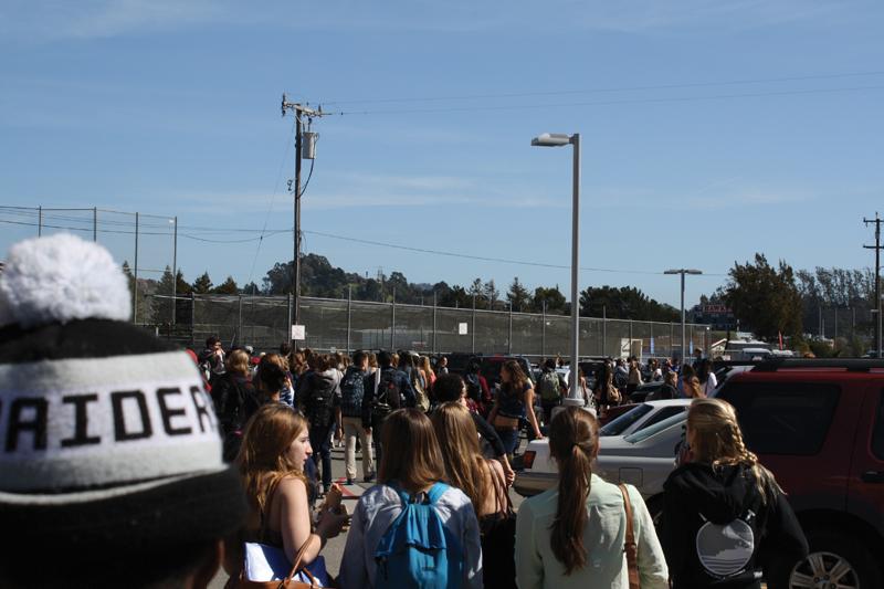 BURNOUT: A fire in a trash can (left) in the boys’ bathroom prompted evacuation of students (right) at the end of lunch on February 28. French teacher Brian Zailian was first to respond to junior Trevor Guyton’s report of the fire. 		   Photo by: Chris Yip