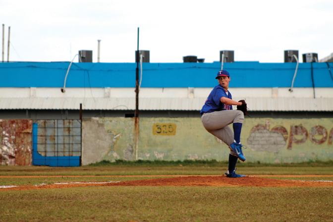 WINDUP: Kenny Rosenberg pitched eight strikeouts during a game in Havana, Cuba on February 15, winning 7-1. The baseball and softball teams spent their Febuary break playing against local teams and experiencing Cuban culture. Photo by: Kristie Lee