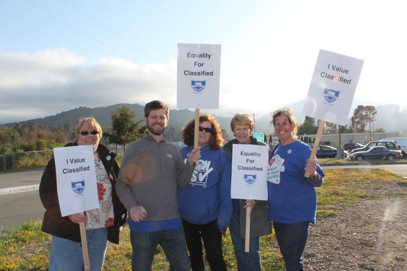 SPEAK UP Classified Staff members display their signs as they protest pay raises and health and retirement benefits.