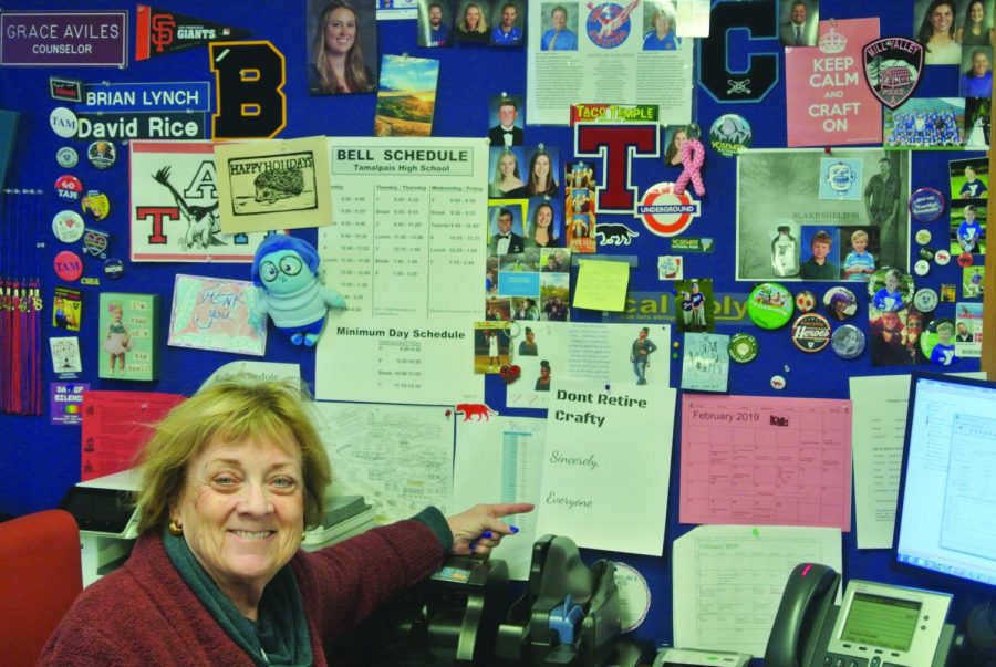 Budget Secretary Carol Craft poses with her wall of mementos.