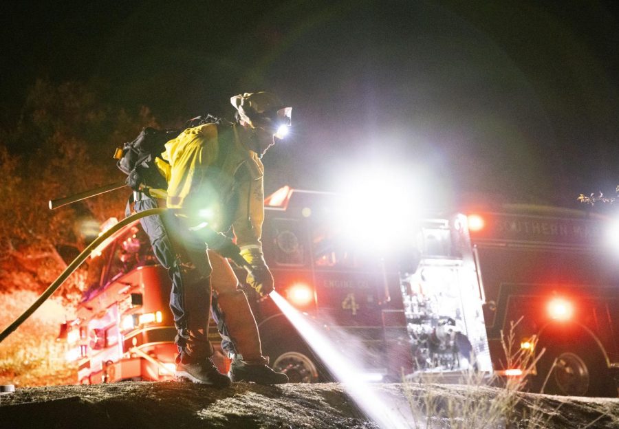 Marin County firefighters put out a small fire on Fern Canyon in Mill Valley the night before the power shutoff. (Ethan Swope) 