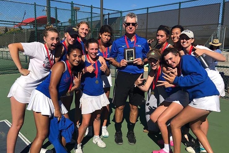 Former girls and boys tennis coach Bill Washauer poses with the girls tennis team after a tournament victory last season. (Courtesy of Tenaya Tremp)