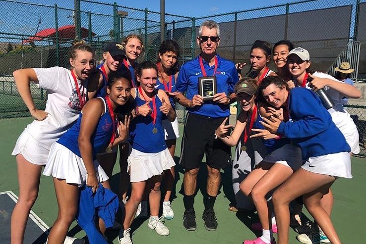 Former girls' and boys' tennis coach Bill Washauer poses with the girls' tennis team after a tournament victory last season. (Courtesy of Tenaya Tremp)