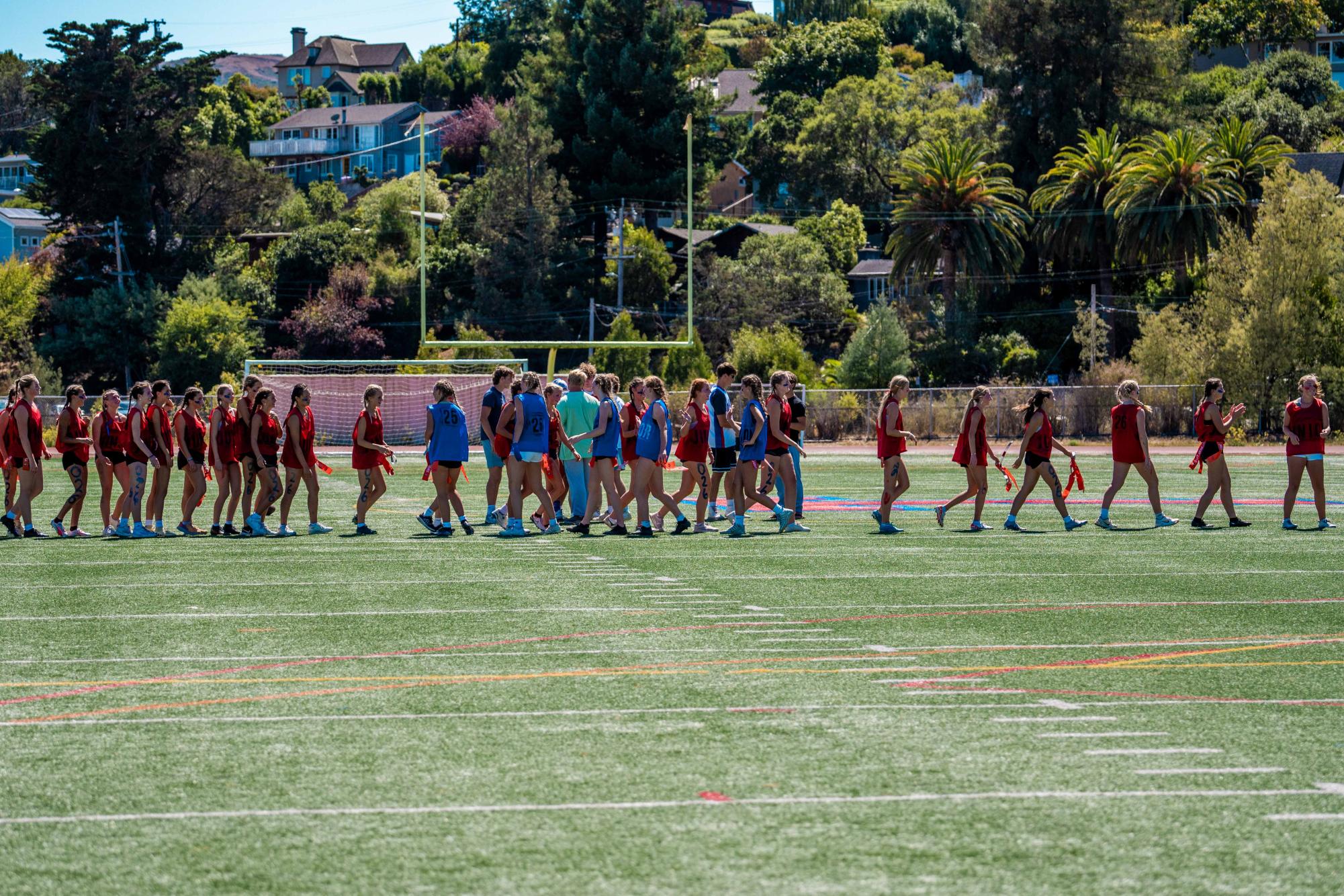 Senior and junior Football Fest teams line up to pay respects after the senior's victory