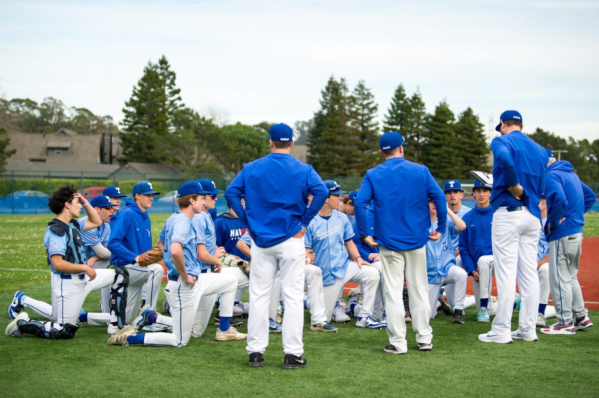 Tam hawks have a post-game meeting after their 11-0 win against De Anza; photo courtesy of Shauna Heidenreich