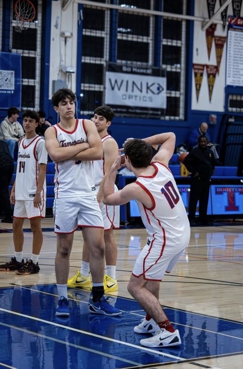 Sophomore Hank Murray and senior Porthos Oliveira perform their pregame handshake.